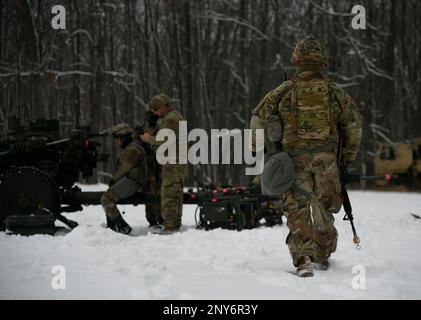 A gun team from the 1-120th Field Artillery Regiment, Wisconsin Army National Guard, set up a M119 howitzer during Northern Strike 23-1, Jan. 21, 2023, at Camp Grayling, Mich.The 120th FA is building readiness by conducting cold-weather training designed to meet objectives of the Department of Defense’s arctic strategy. Stock Photo