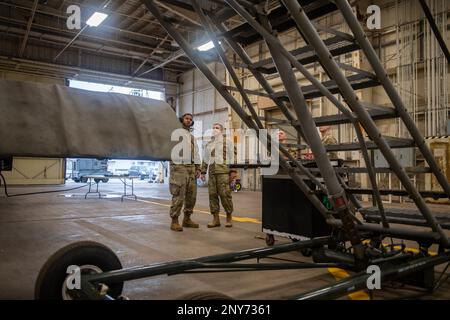 U.S. Air Force Staff Sgt. Andre Butler, 718 Aircraft Maintenance Squadron HH-60G Pave Hawk maintainer, left, briefs Chief Master Sgt. Shawn Aiello, 5th Air Force command chief, on the on-going maintenance of the helicopters at Kadena Air Base, Japan, Feb. 14, 2023. Aiello’s visit facilitated open and honest conversation about the infrastructure and limiting factors specific to Kadena AB. Stock Photo