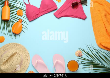 Frame made with different beach objects on light blue background, flat lay. Space for text Stock Photo