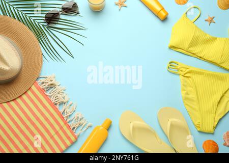Frame made with different beach objects on light blue background, flat lay. Space for text Stock Photo