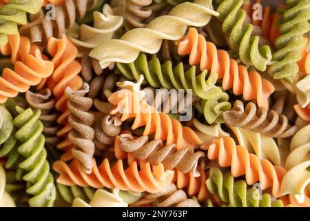 A variety of fusilli pasta made from different types of legumes, green and red lentils, mung beans and chickpeas. Gluten-free pasta. Food background Stock Photo