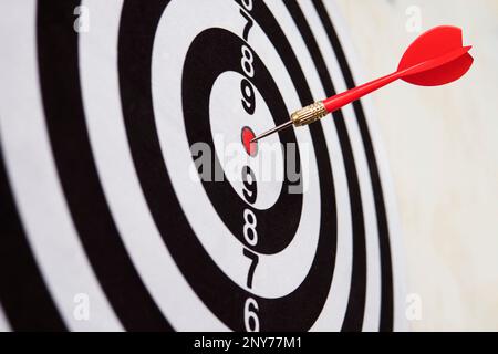 Red dart on board right direction hit target goal. Competition game to win focus on achievement with smart thinking planning accurate strategy. Outsta Stock Photo