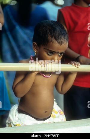 Girl, Kerala, India. Ezhuthiniruthu ceremony on Vijayadasami day in Saraswathy temple at Panachikkadu near kottayam, Kerala, India Stock Photo