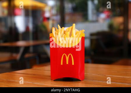 MYKOLAIV, UKRAINE - AUGUST 11, 2021: Big portion of McDonald's French fries on table in cafe Stock Photo