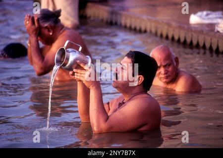 A Pilgrim pays homage to the Mother of River Ganga Ganges Ghats at Varanasi Benaras, Uttar Pradesh, India, Asia Stock Photo