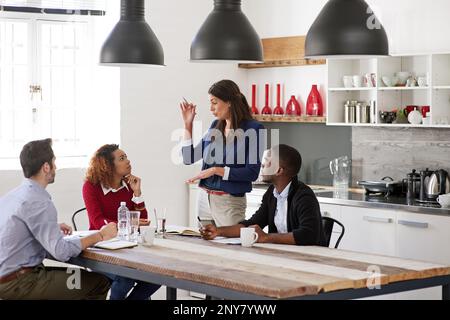 Sharing her ideas with the team. young designers discussing work together in an office. Stock Photo