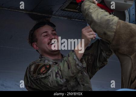 U.S. Air Force Senior Airman Derrick Studer, 317th Aircraft Maintenance Squadron crew chief, holds a panel in place on a C-130J Super Hercules at Pope Army Airfield, North Carolina, Jan. 25, 2023. During Battalion Mass Tactical Week, Studer organized and completed aircraft maintenance ensuring that each C-130 was mission capable. Stock Photo