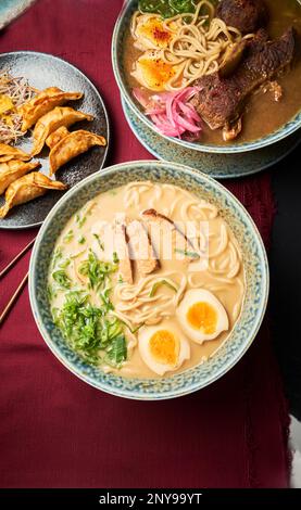 A vertical top view of steaming hot Japanese dishes ready to serve Stock Photo