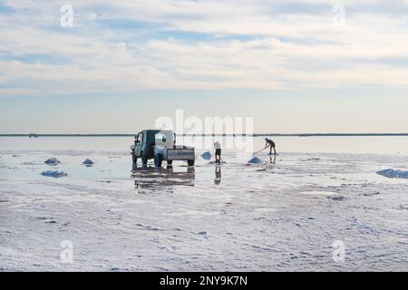 Salt mining on lake burlinskoye. bursol'. Altai territory. Russia. Salt piles and water pool on Salinas Grandes salt flats Stock Photo