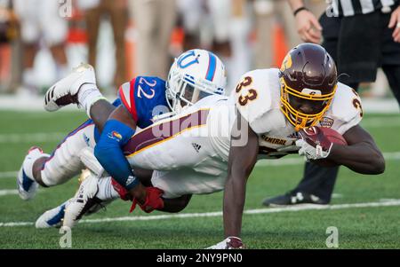 LAWRENCE, KS - SEPTEMBER 09: Central Michigan Running Back Kumehnnu Gwilly  (33) break through the tackle of Kansas Safety Bryce Torneden (1) during  the game between Central Michigan and Kansas on Saturday