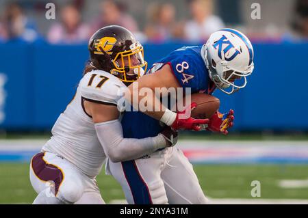 LAWRENCE, KS - SEPTEMBER 09: Central Michigan Running Back Kumehnnu Gwilly  (33) break through the tackle of Kansas Safety Bryce Torneden (1) during  the game between Central Michigan and Kansas on Saturday