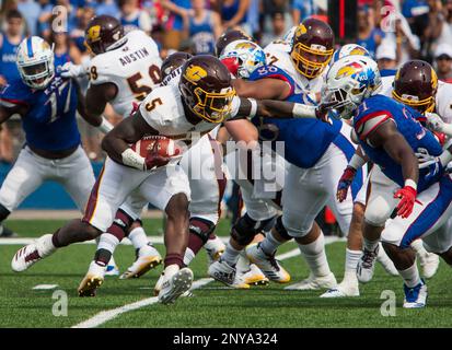 LAWRENCE, KS - SEPTEMBER 09: Central Michigan Running Back Kumehnnu Gwilly  (33) break through the tackle of Kansas Safety Bryce Torneden (1) during  the game between Central Michigan and Kansas on Saturday