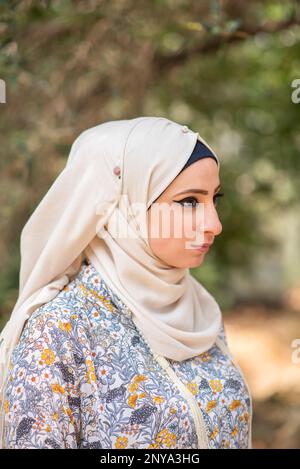 Side view of beautiful Muslim woman looking away outdoors Stock Photo