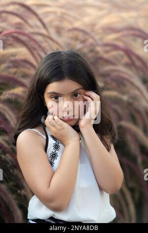 Scared girl hands touching face outdoors Stock Photo