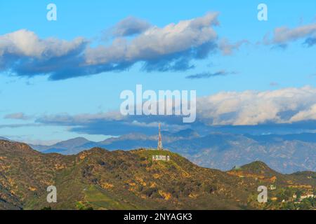 LOS ANGELES, CALIFORNIA - JANUARY 18, 2023: Distant view of the Hollywood Hills with clouds and dramatic lighting at sunset Stock Photo