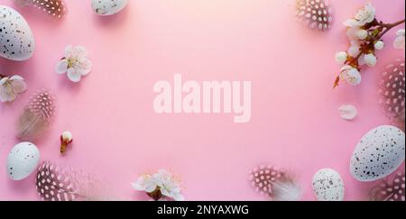 Easter border frame of Easter eggs and spring flowers with copy space in the middle Stock Photo