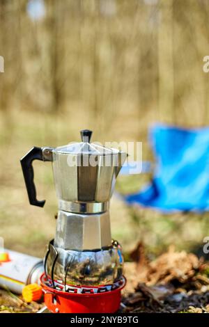 https://l450v.alamy.com/450v/2nyb9tg/making-camping-coffee-from-a-geyser-coffee-maker-on-a-gas-burner-autumn-outdoor-male-prepares-coffee-outdoors-travel-activity-for-relaxing-2nyb9tg.jpg