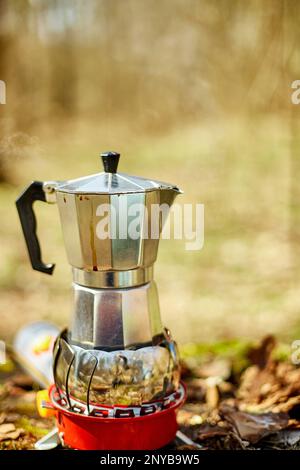 https://l450v.alamy.com/450v/2nyb9w5/making-camping-coffee-from-a-geyser-coffee-maker-on-a-gas-burner-autumn-outdoor-male-prepares-coffee-outdoors-travel-activity-for-relaxing-2nyb9w5.jpg