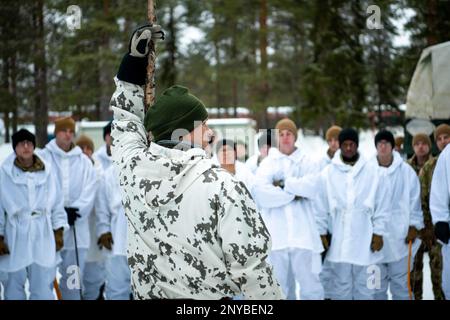 U.S. Army Soldiers with Charlie Troop, 3-71st Cavalry Regiment, 1st Brigade Combat Team, 10th Mountain Division, receive instructions from a Finnish winter warfare instructor before conducting ski familiarization training during Arctic Forge 23 on Sodankylä Garrison, Finland, Feb 18, 2023. Exercise Arctic Forge 23 is a U.S. Army Europe and Africa led umbrella exercise that leverages the host nation exercises Defense Exercise North in Finland, and exercise Joint Viking in Norway, taking place Feb. 16 through March 17, 2023, focused on building capabilities and cooperation in support of the U.S. Stock Photo