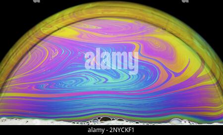 bubble soap lit below reveals a multitude of color nuances Stock Photo
