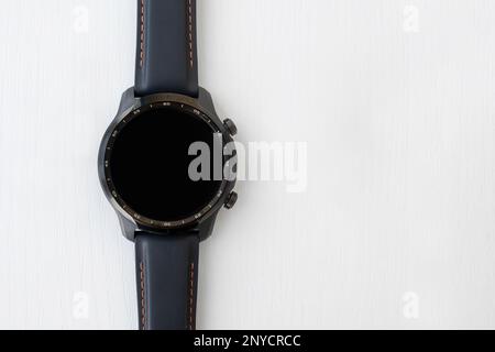 Top view of black smartwatch with empty touch screen display. Fitness tracker on white background. copy space Stock Photo