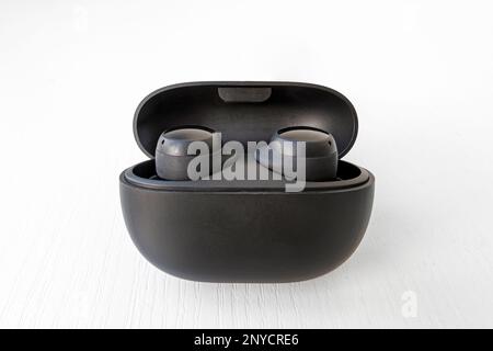wireless headphones black color with box and charger on white background. box with wireless headphones. Stock Photo
