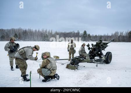 A gun team from the 1-120th Field Artillery Regiment, Wisconsin Army National Guard, set up a M119 howitzer during Northern Strike 23-1, Jan. 25, 2023, at Camp Grayling, Mich. Units that participate in Northern Strike’s winter iteration build readiness by conducting joint, cold-weather training designed to meet objectives of the Department of Defense’s Arctic Strategy. Stock Photo