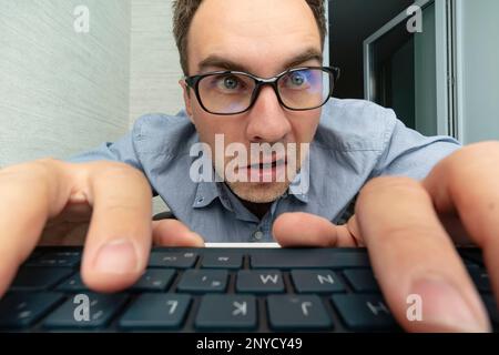 Funny and crazy man using a computer on white background. man's hands on keyboard Stock Photo