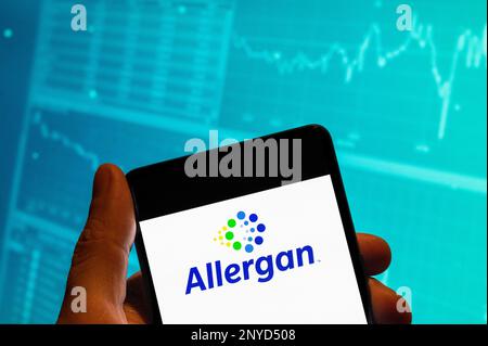 China. 19th Feb, 2023. In this photo illustration, the Irish-domiciled pharmaceutical company, Allergan logo is seen displayed on a smartphone with an economic stock exchange index graph in the background. Credit: SOPA Images Limited/Alamy Live News Stock Photo