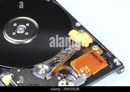 Close up view of internal computer hard drive 2.5" SAS, can see disk surface and head with shallow focus isolated on white background. Stock Photo