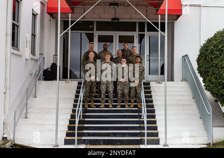 U.S. Marines gather for a photo on the steps of the air traffic control tower during a tour with Deputy Commandant of Manpower and Reserve Affairs Lt Gen. James Glynn, Marine Corps Air Station (MCAS) Cherry Point, North Carolina, Feb. 1, 2023. The tour allowed the group to discuss the vision for MCAS Cherry Point under Force Design 2030 and plans for improving retention rates of Marines and Sailors. Stock Photo