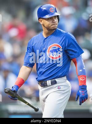 Javier Baez of the Chicago Cubs spits out seeds in the dugout