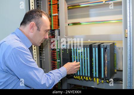 technician in server room at the data centre Stock Photo