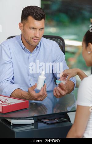 showing solution for contact lenses to a customer Stock Photo