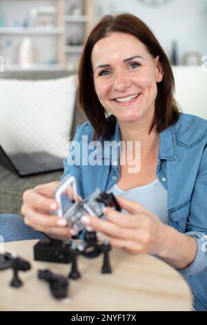 female engineer or tech repairs electronic device Stock Photo