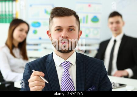 Confident smiling business man professional trainer with holding pen Stock Photo