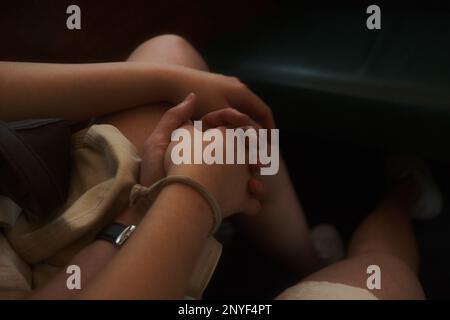 Close-up photo of hand holding in public Stock Photo