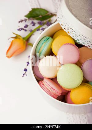 Colorful macaroons in a gift box on a white table Stock Photo