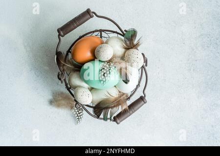 From above basket with easter card concept with eggs on concrete background Stock Photo