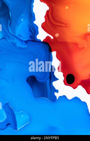 Beautiful abstraction of liquid paints in slow blending flow mixing together gently Stock Photo