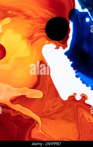 Beautiful abstraction of liquid paints in slow blending flow mixing together gently Stock Photo