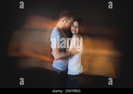 Couple embracing posing in studio Stock Photo