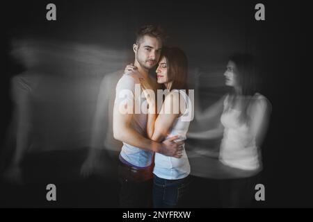 Couple embracing posing in studio Stock Photo