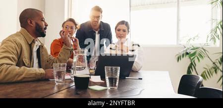 Diverse businesspeople having a discussion during a meeting in an office boardroom. Group of creative business colleagues collaborating on a new proje Stock Photo
