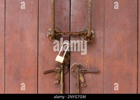 Closed padlock hangs on the old doors. Stock Photo