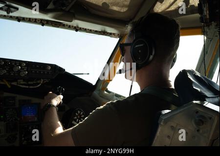 U.S. Air Force Maj. Godfrey Brackney, 91st Expeditionary Air Refueling Squadron KC-135 Stratotanker pilot, flies the aircraft during an aerial refueling mission within the U.S. Central Command area of responsibility, Feb. 8, 2023. The 91st EARS delivers fuel for U.S. and partner nation forces, extending the reach and combat effectiveness of airpower to the region. Stock Photo