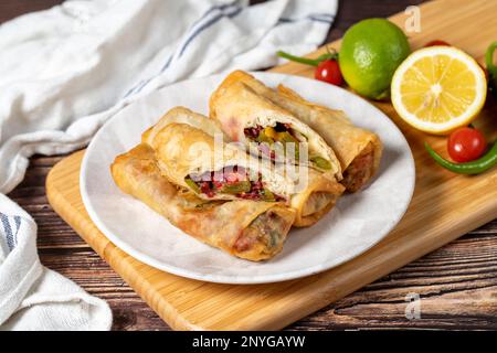 Pacanga pastry. Turkish cuisine delicacies. Pastry made with phyllo, tomato, green pepper, capia pepper, cheddar cheese and pastrami. Ramadan food. Lo Stock Photo