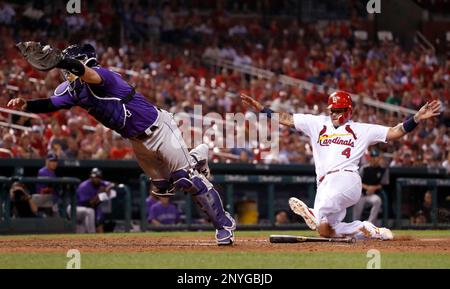 St. Louis Cardinals catcher Yadier Molina, left, celebrates with relief  pitcher Seung-Hwan Oh after he retired the Colorado Rockies' Tony Wolters  for the final out in the ninth inning of a baseball