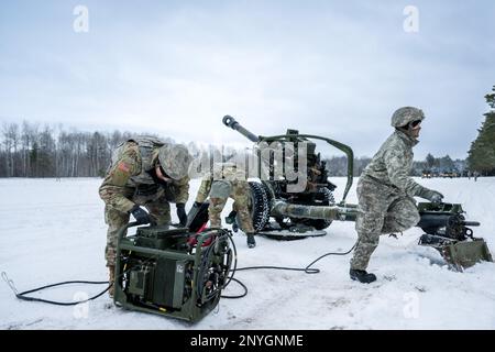 A gun team from the 1-120th Field Artillery Regiment, Wisconsin Army National Guard, set up a M119 howitzer during Northern Strike 23-1, Jan. 25, 2023, at Camp Grayling, Mich. Units that participate in Northern Strike’s winter iteration build readiness by conducting joint, cold-weather training designed to meet objectives of the Department of Defense’s Arctic Strategy. Stock Photo