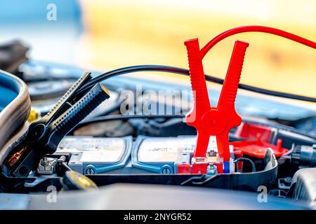 starting the car using the starter cables Stock Photo